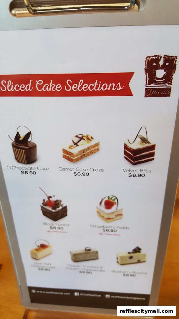 A menu display showcasing various sliced cakes with their names and prices.
