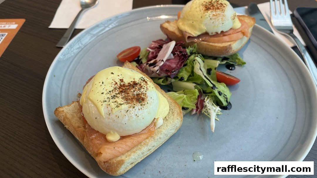 A plate of Eggs Benedict with smoked salmon and a side salad.