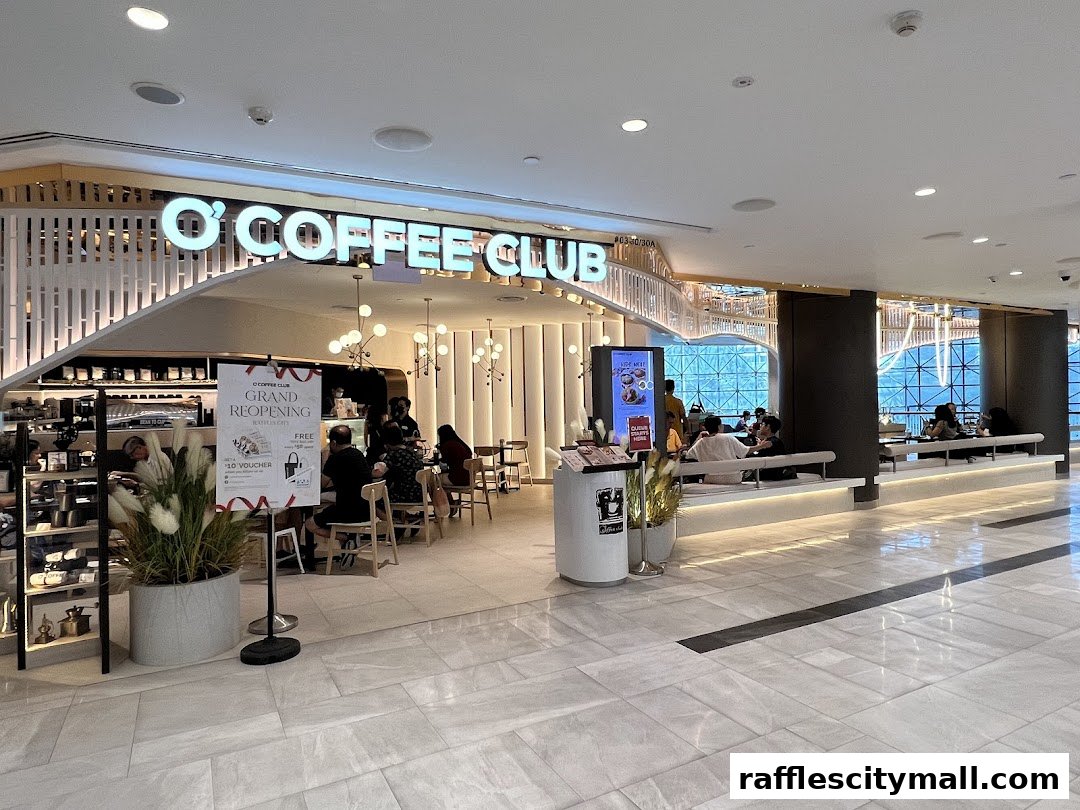 Interior view of O'Coffee Club Raffles City with customers seated and a grand reopening sign.
