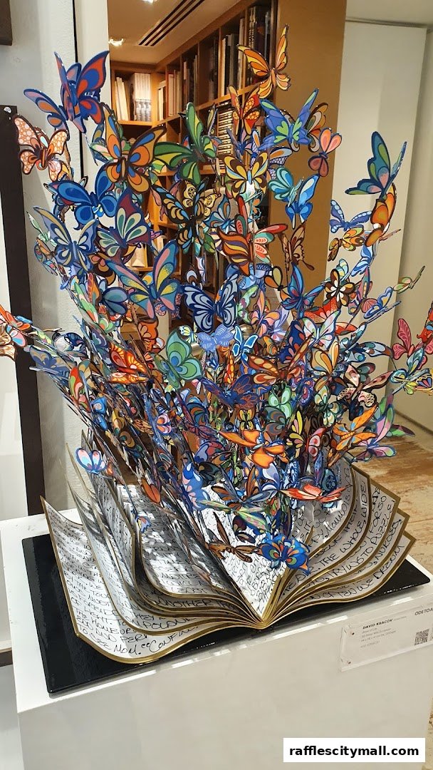 A vibrant sculpture of butterflies emerging from an open book.
