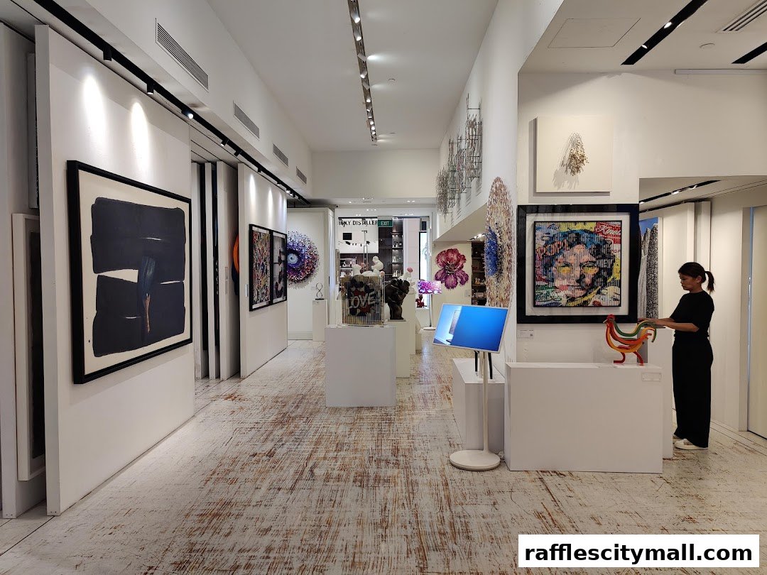 Interior view of an art gallery with various artworks displayed and a person browsing.