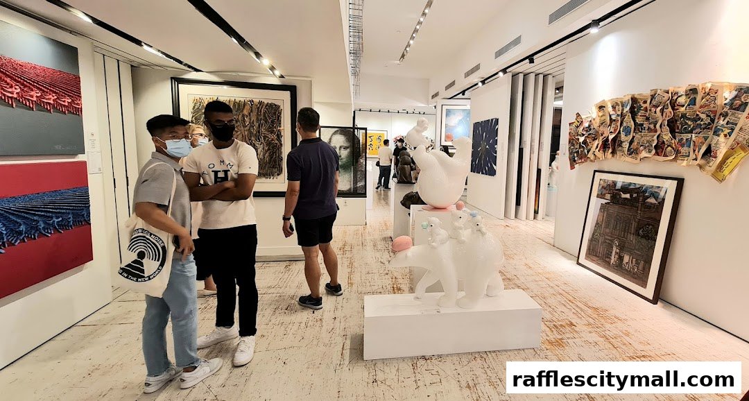 Visitors admire diverse artworks, including paintings and sculptures, in a well-lit gallery space.