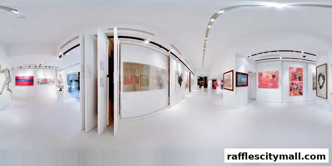 Interior view of a modern art gallery showcasing various paintings and sculptures.