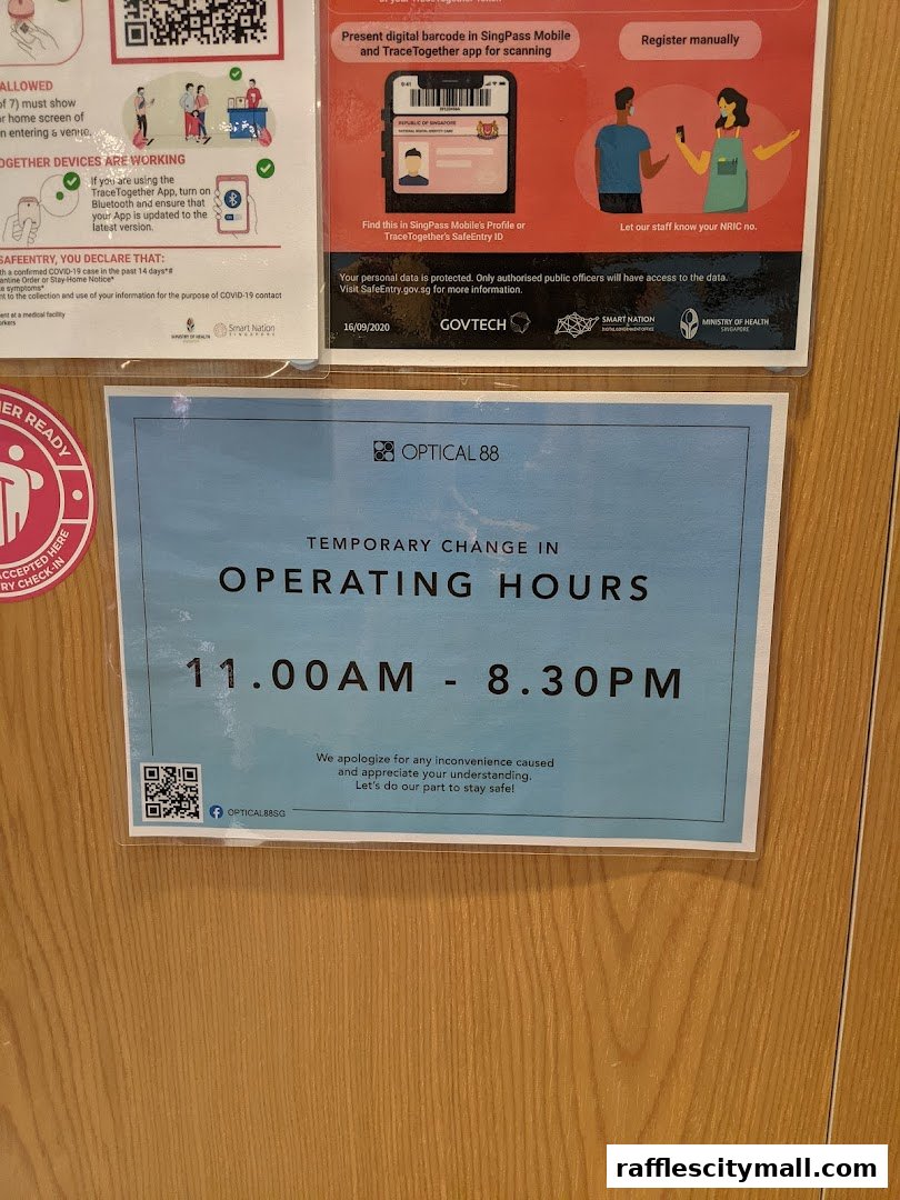 A sign announcing temporary operating hours for Optical 88 Raffles City.
