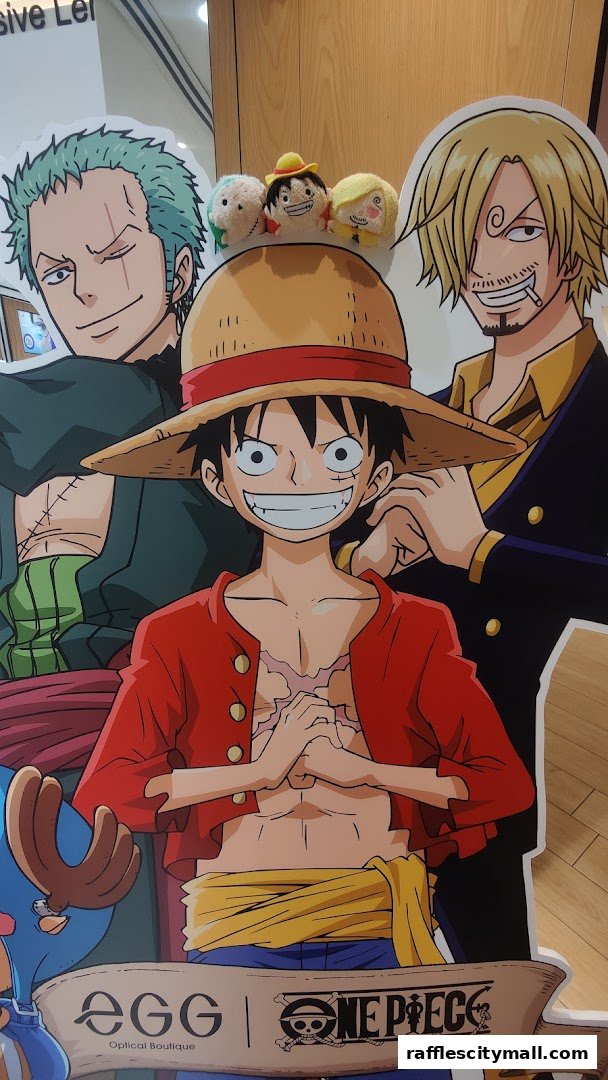 Cardboard cutouts of One Piece characters and plush toys at Optical 88 Raffles City.