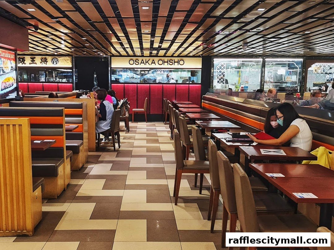 Interior view of Osaka Ohsho restaurant with booth seating and tables.