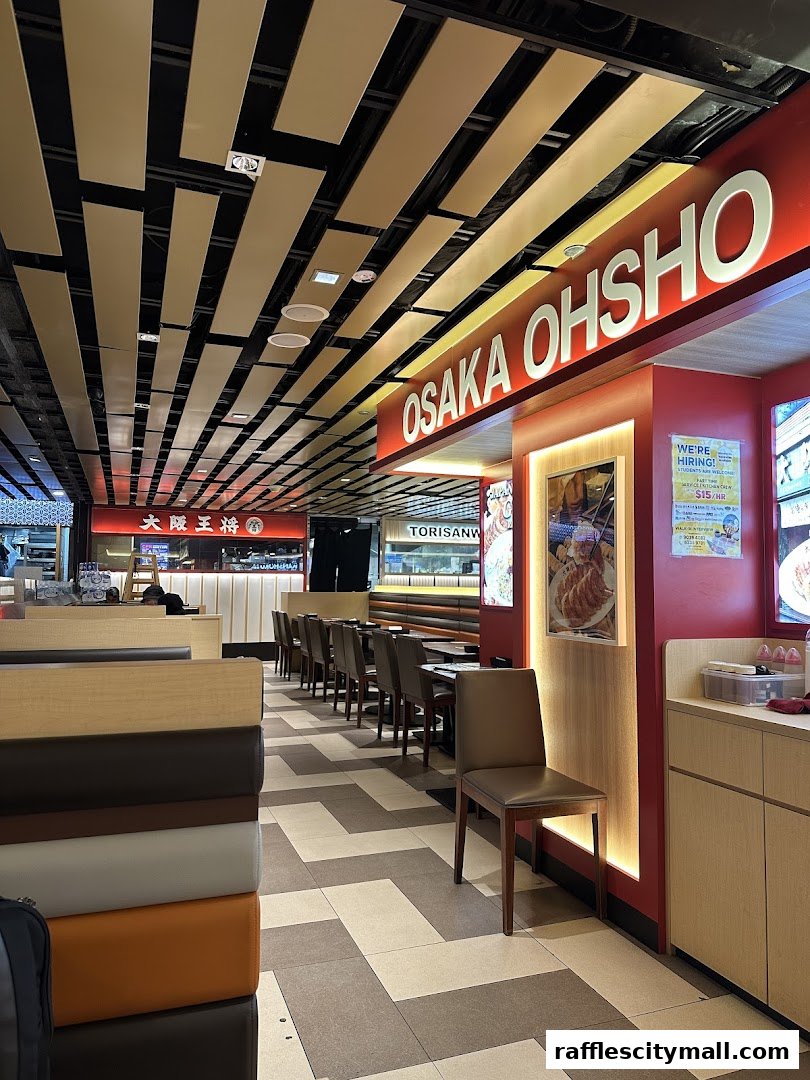 Interior view of Osaka Ohsho restaurant with seating and prominent signage.