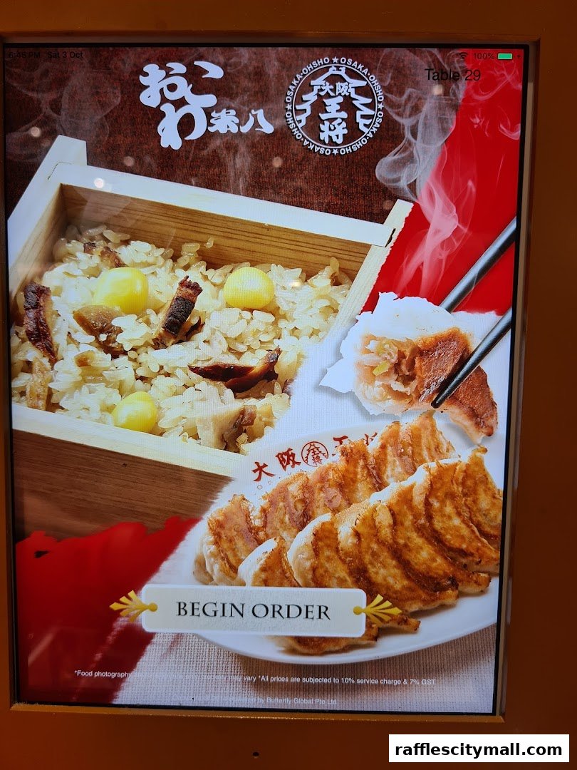 A digital menu displays steaming rice and pan-fried dumplings with a 'Begin Order' button.