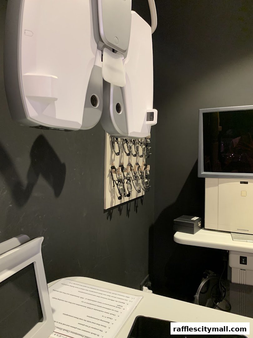 Interior shot of an optometry clinic with eye examination equipment and glasses display.
