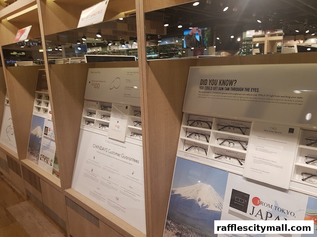 Interior view of an OWNDAYS eyewear shop displaying various glasses and promotional information.