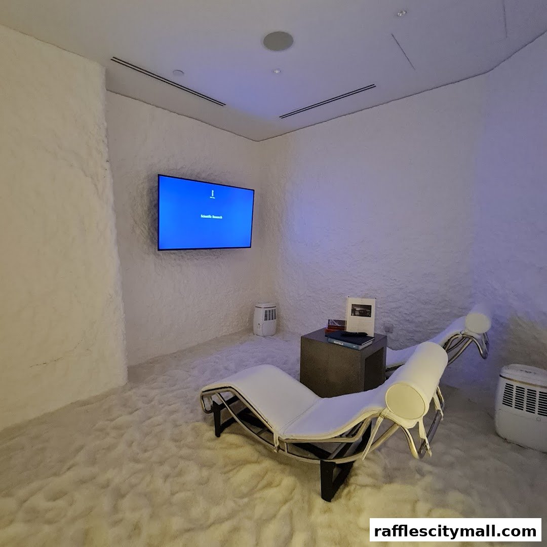 A serene salt room with chaise lounges, a TV, and Himalayan salt walls.