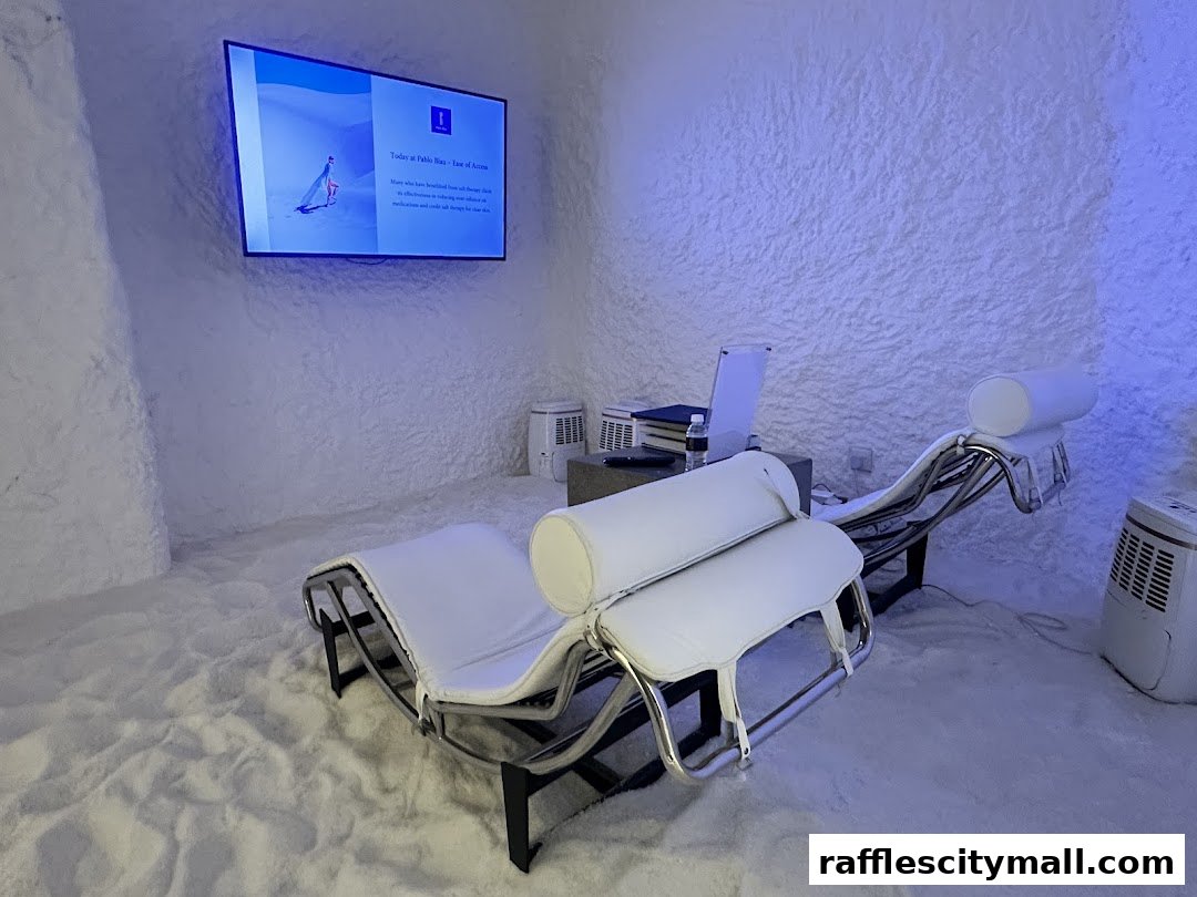 A serene salt room with comfortable lounge chairs and a screen displaying information.