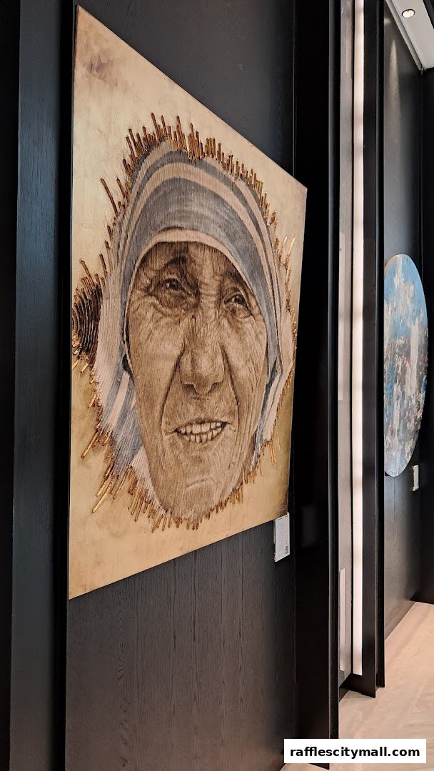 A striking portrait artwork of Mother Teresa displayed on a dark wooden wall.