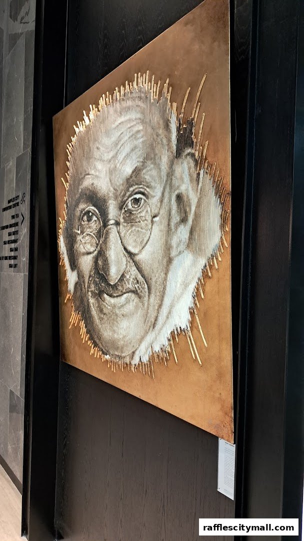 A striking portrait of Mahatma Gandhi is displayed on a textured wall.