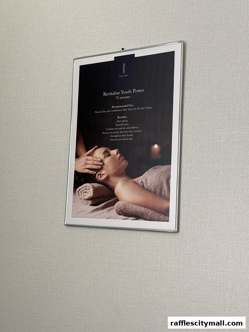 A framed poster advertising a 'Revitalise Youth Power' treatment at Pablo Blau.