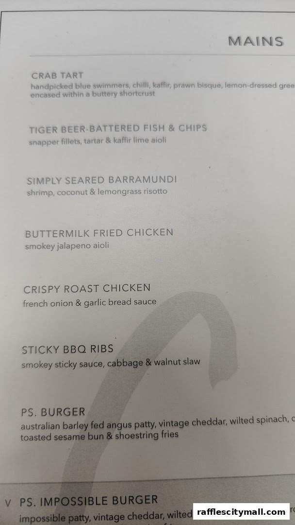 A menu from PS.Cafe Raffles City featuring main courses like crab tart and burgers.