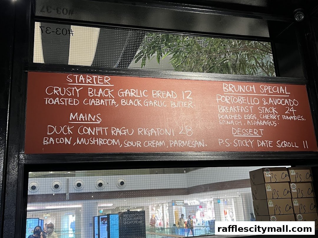 A chalk-written menu board for PS.Cafe Raffles City, featuring starters, mains, brunch specials, and desserts.