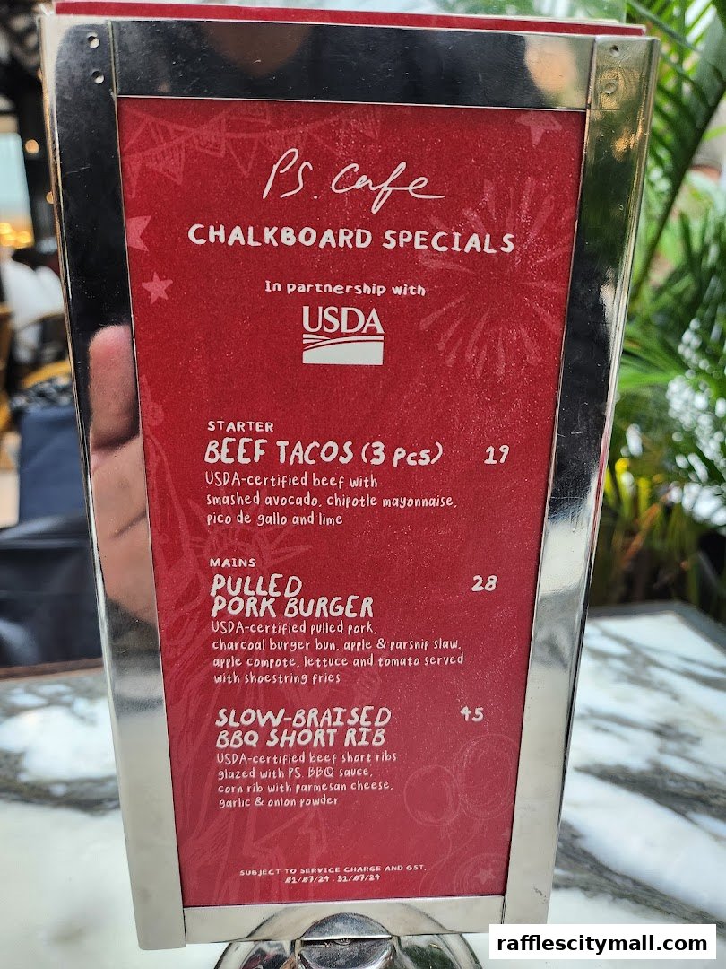 A menu board from PS. Cafe featuring chalkboard specials with USDA partnership.