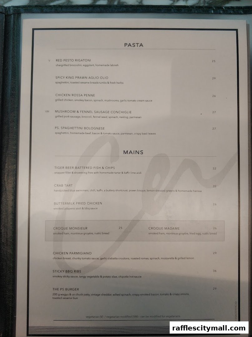 A menu from PS.Cafe Raffles City featuring pasta, mains, and burgers with prices.