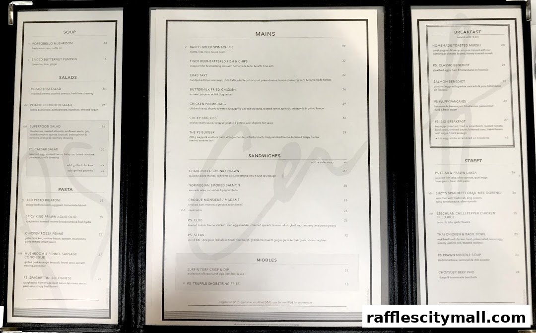 A menu from PS.Cafe Raffles City featuring soups, salads, pasta, mains, sandwiches, nibbles, street food, and breakfast items.