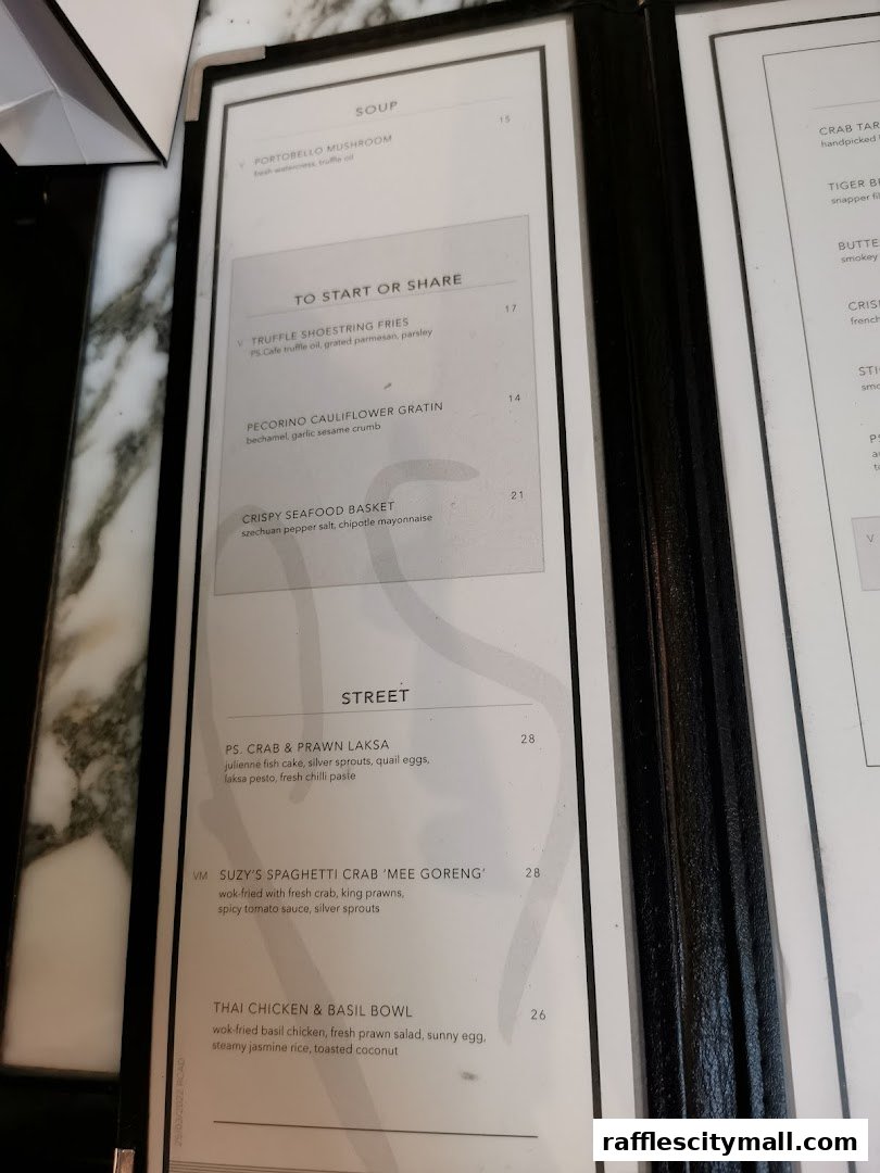 A menu from PS.Cafe Raffles City featuring soups, starters, and street food dishes.