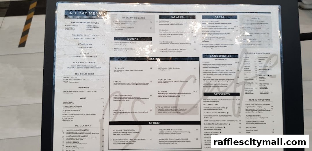 A close-up of an 'All Day Menu' from PS.Cafe Raffles City, showcasing various food and drink categories.