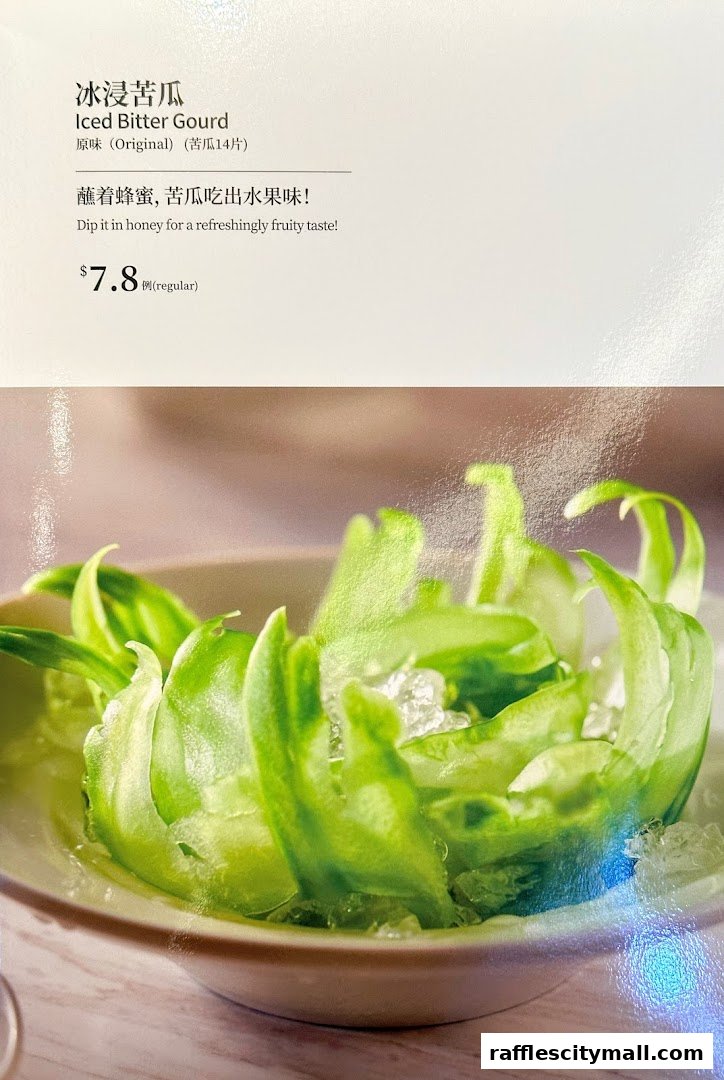 A close-up of Iced Bitter Gourd with honey, presented in a bowl with ice.