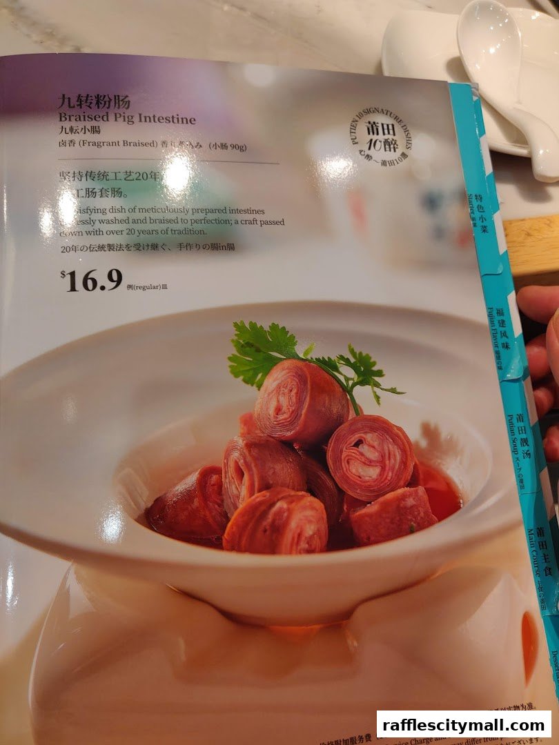 A menu item featuring Braised Pig Intestine with a detailed description and price.