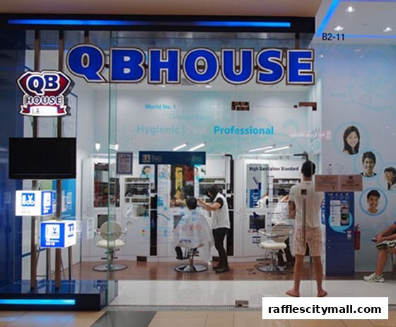 QB HOUSE barbershop with customers getting haircuts inside.