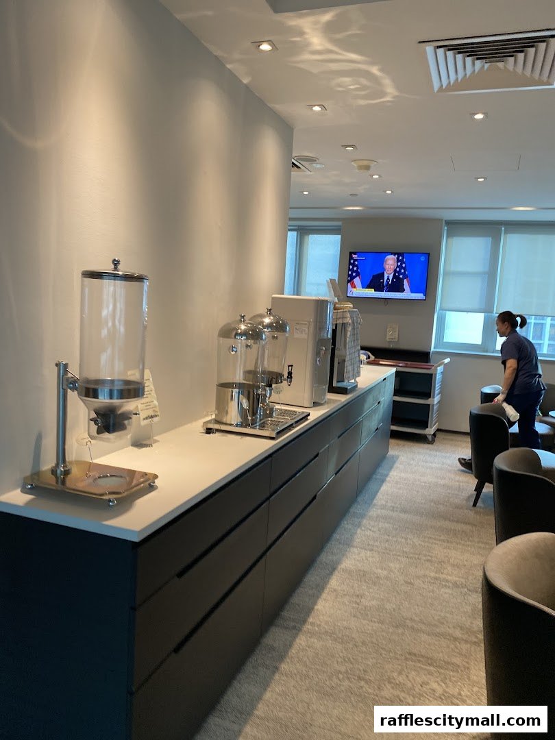 A waiting area with a counter, dispensers, and a TV showing a news broadcast.