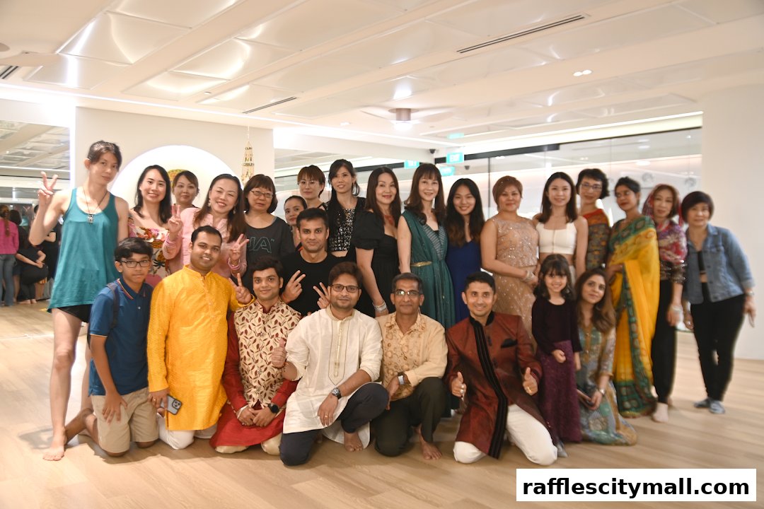 A group of people, including men, women, and a child, posing for a photo indoors.