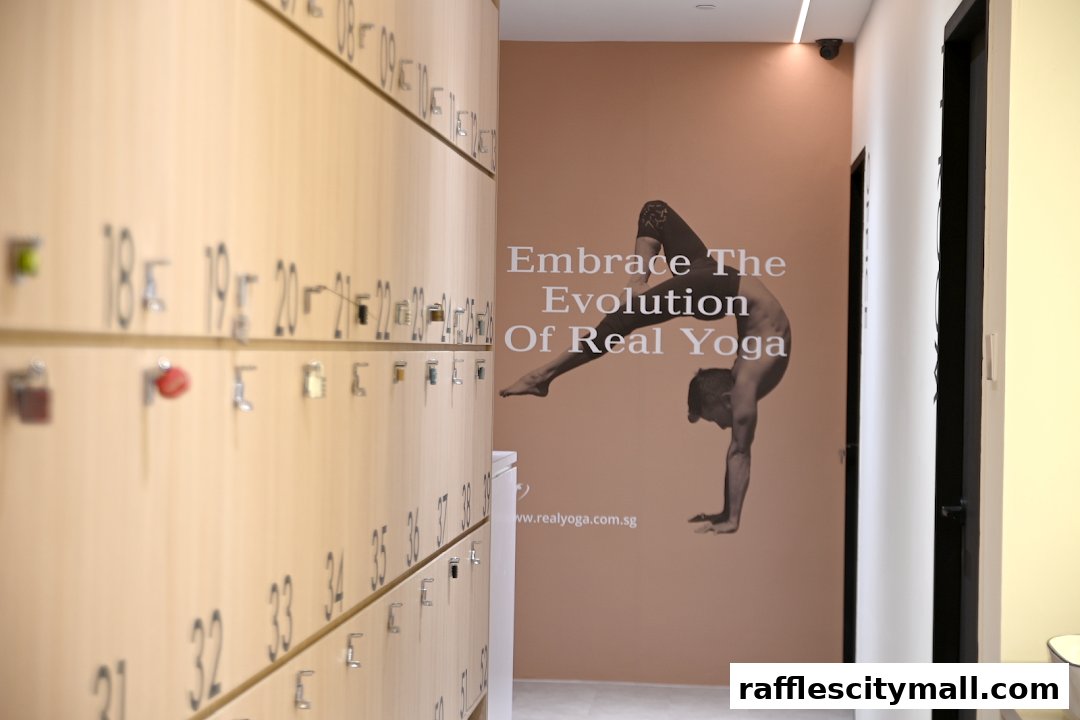 Interior shot of a yoga studio with lockers and a motivational yoga pose mural.