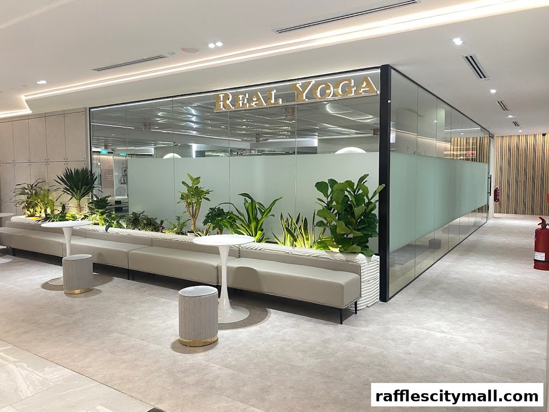 Interior of a modern yoga studio with a reception area and plants.