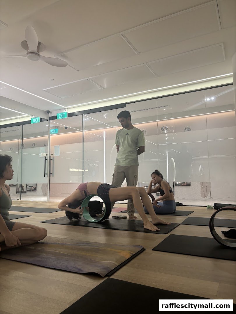 People practicing yoga in a studio with a yoga instructor.