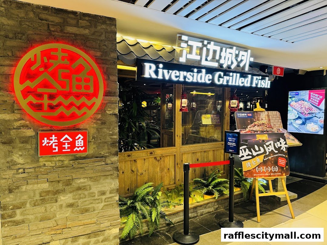 The entrance of Riverside Grilled Fish restaurant with a prominent red and gold sign.