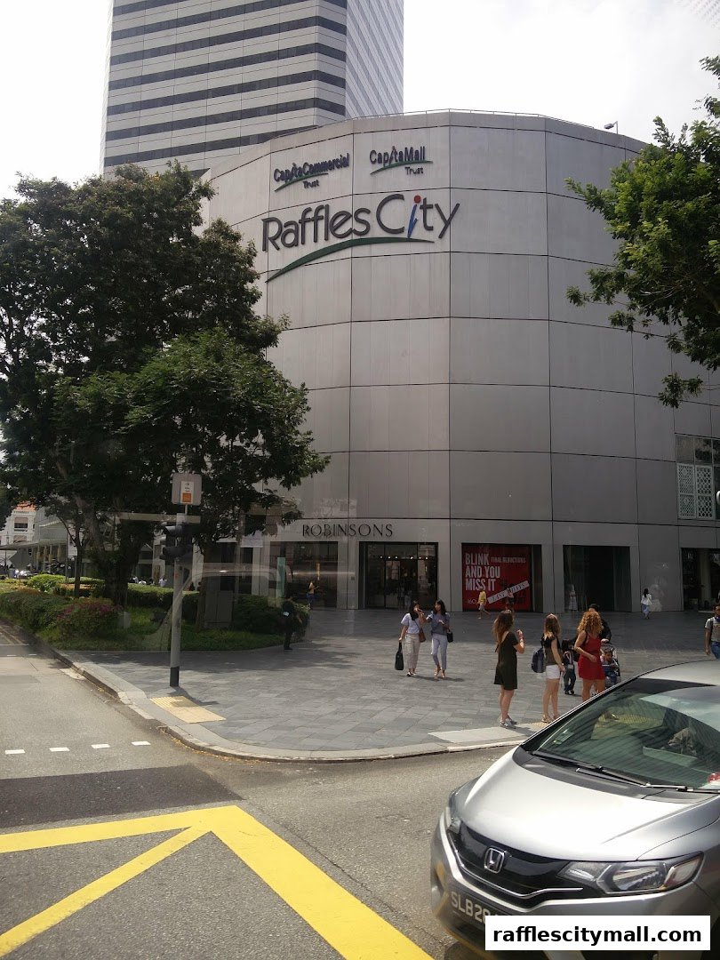 The exterior of Raffles City shopping mall with Robinsons department store entrance.