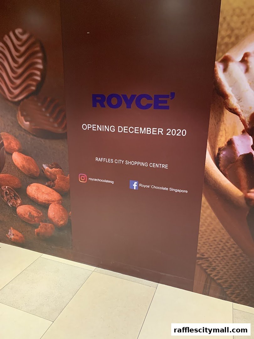 A sign for Royce' chocolate shop announcing its opening in December 2020.