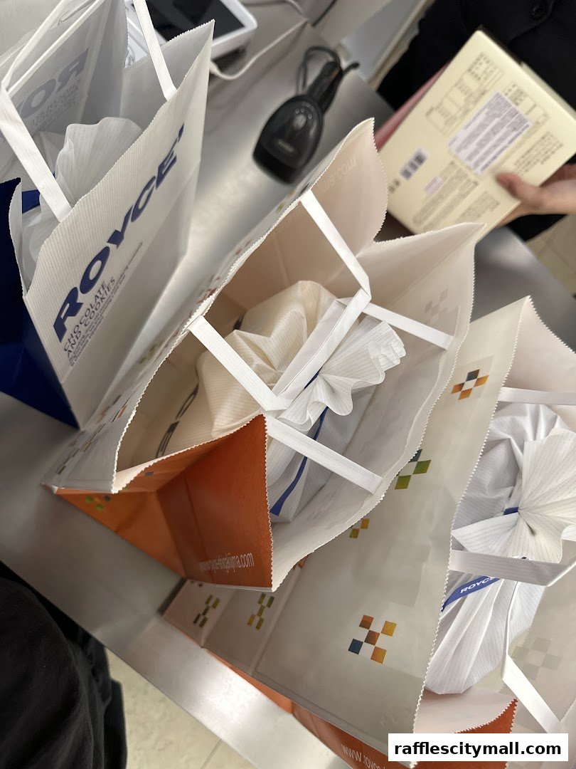Several Royce shopping bags filled with products, suggesting a recent purchase.