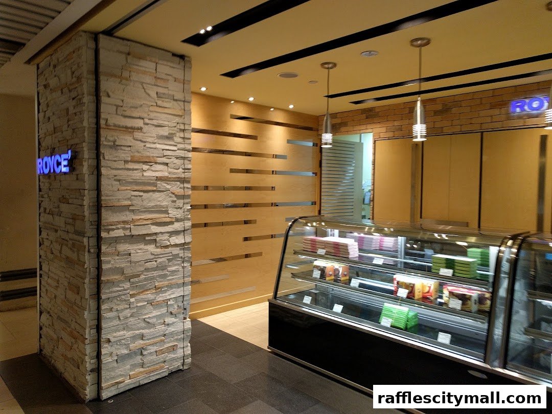 The Royce shop entrance features a stone pillar with the shop's name and a display case with packaged goods.