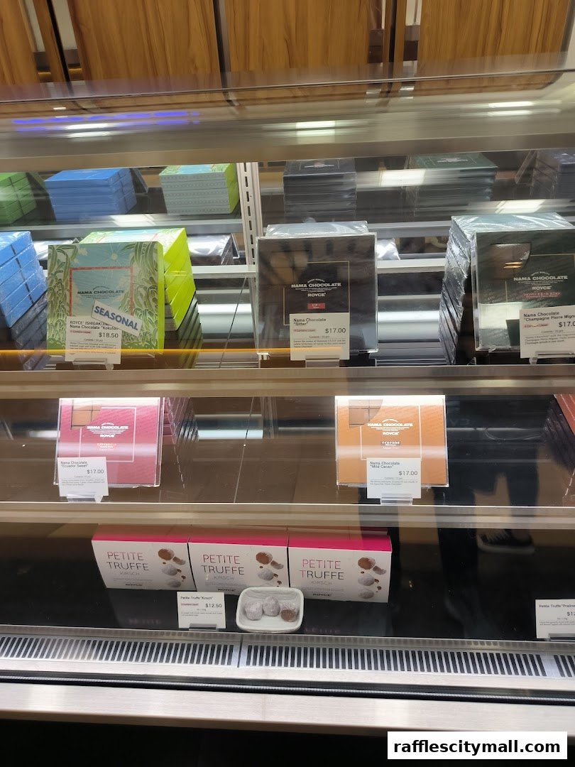 A display case filled with various Royce Nama Chocolate boxes and Petite Truffles.