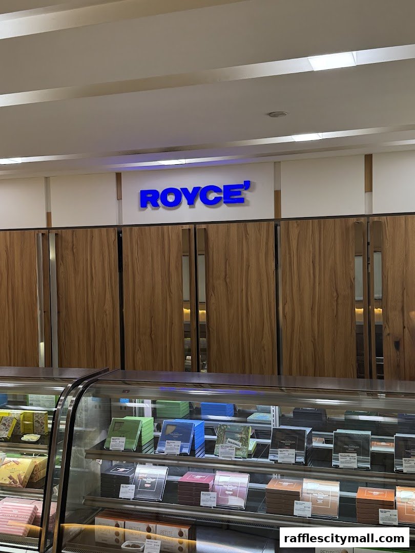 The Royce shop front displays a variety of chocolates in a refrigerated display case.