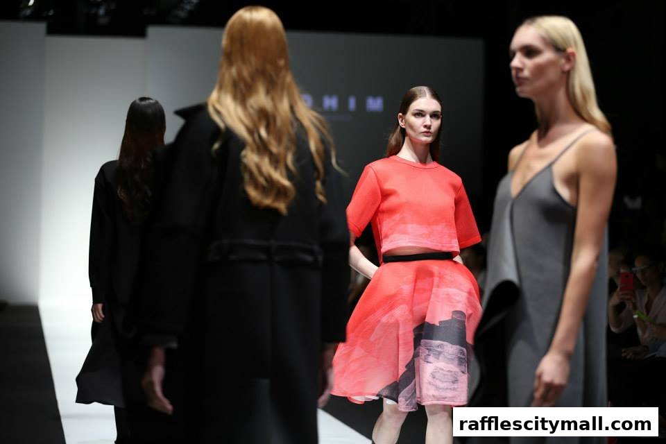Models showcase designer outfits on a fashion runway.