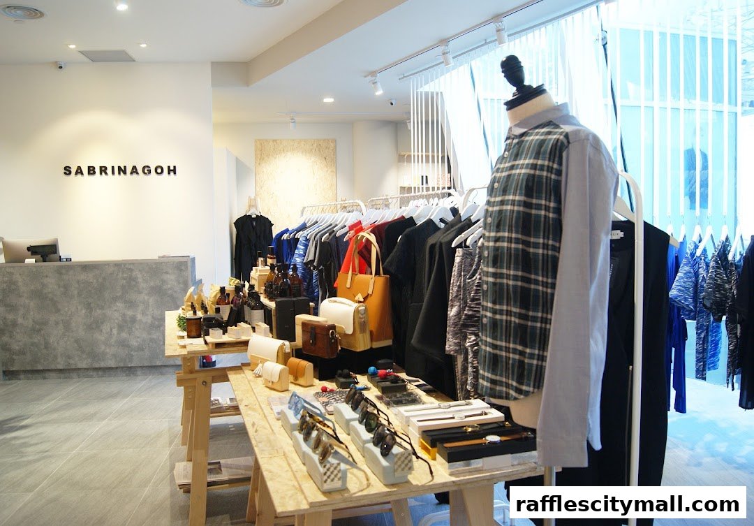 Interior view of a modern boutique with clothing racks, accessories, and a display counter.