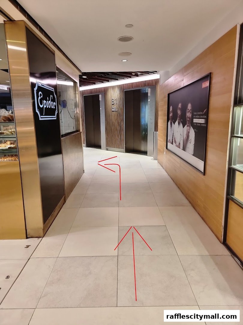 A hallway with elevators and a sign for 'Epidor' bakery, with red arrows indicating direction.