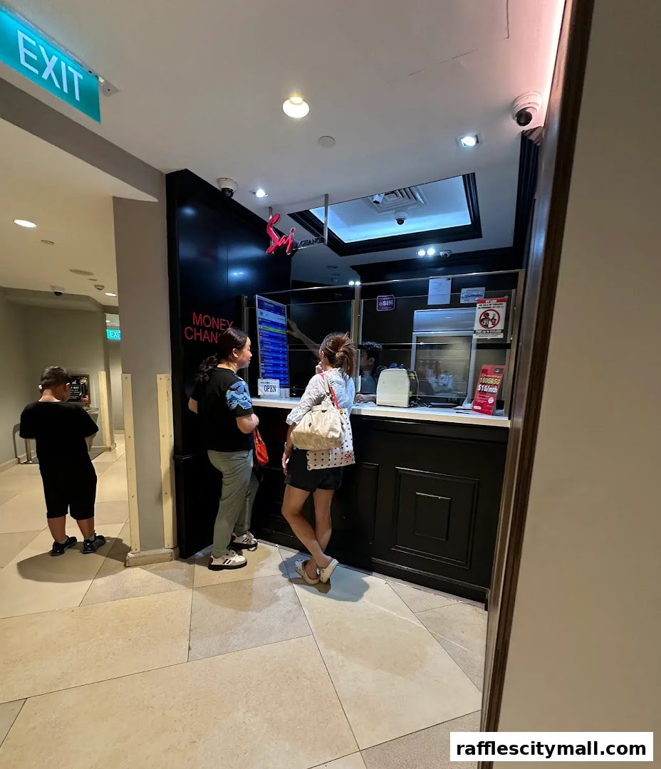 Customers at a money exchange counter with exchange rates displayed.