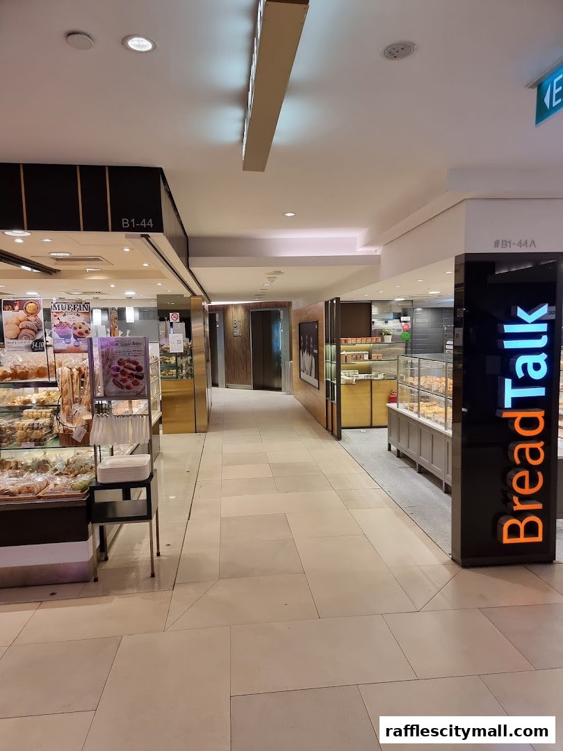 A view of a shopping mall corridor with two bakeries, BreadTalk and another unnamed bakery.