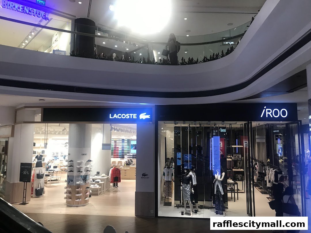 Two retail shops, Lacoste and iROO, are displayed in a mall with mannequins and merchandise.