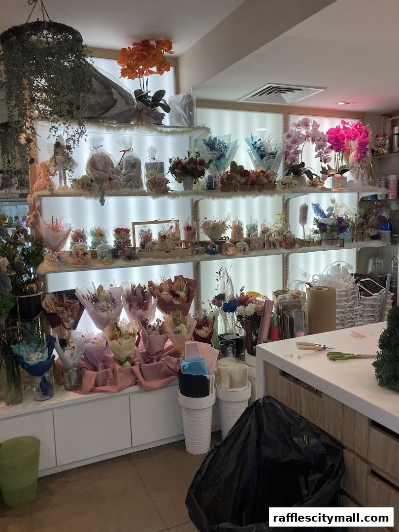 A well-lit flower shop interior showcasing a variety of bouquets and floral arrangements on shelves and display tables.