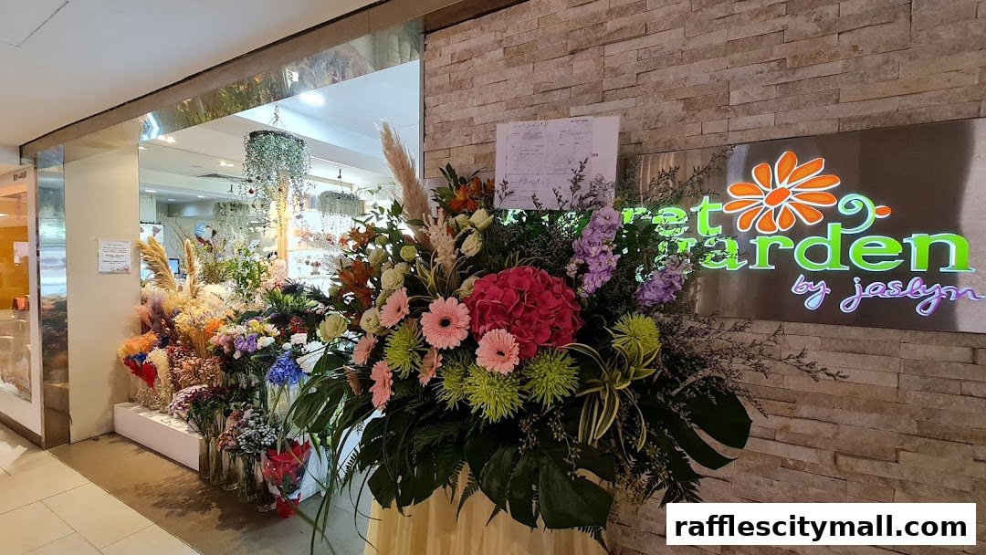 A vibrant flower shop entrance with a large floral arrangement and the shop's illuminated sign.
