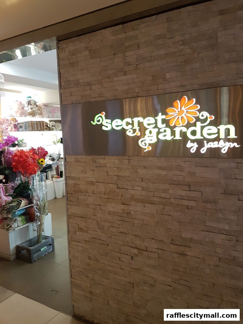 The entrance to the Secret Garden shop, featuring a stone facade and illuminated signage.